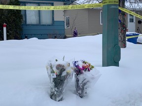 Flowers are placed in front of a house, the scene of a triple homicide, in Prince Albert, Sask. on April 1, 2020 in a handout photo. A man has been arrested in what a Saskatchewan police chief calls a horrific killing of a seven-year-old boy and his grandparents.