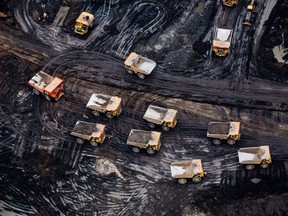 Heavy haulers are seen at the Suncor Energy Inc. Fort Hills mine in this aerial photograph taken above the Athabasca oilsands near Fort McMurray, Alberta.