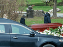 Mourners maintain physical distancing as they pay respects at a funeral in Toronto on April 14, 2020.