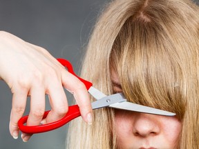 girl cutting her own hair