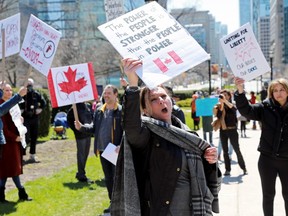 Protesters demand the removal of provincial coronavirus disease restrictions outside Queen's Park in Toronto, April 25, 2020.