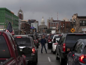 Hundreds of supporters of the Michigan Conservative Coalition protest against the state's extended stay-at-home order at the Capitol building in Lansing, Michigan, U.S., April 15, 2020.