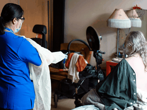 A personal support worker with the West Neighbourhood House’s Parkdale Assisted Living Program prepares to help a resident wash in Toronto.