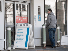 A sign outside Lions Gate Hospital in North Vancouver, B.C., explains visitor restrictions to limit the spread of the novel coronavirus COVID-19.