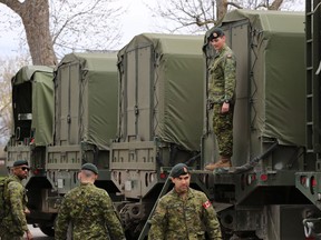 Reservists help pack military vehicles with boats and fuel at CFB Kingston Kingston, Ont., on May 9, 2017. The federal government is planning to offer full-time employment to all reservists in the Canadian Armed Forces until the end of the summer.