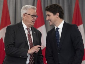 Prime Minister Justin Trudeau and FCM President Bill Karsten speak before a meeting with the Federation of Canadian Municipalities in Ottawa on November 28, 2019. The voice of Canadian municipalities says communities across the country are facing a financial crisis due to COVID-19 that puts people at further risk. Federation of Canadian Municipalities president Bill Karsten is telling the House of Commons finance committee that plummeting revenues are endangering essential services, from policing to garbage collection.
