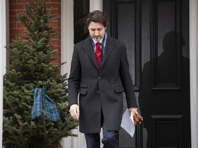 Prime Minister Justin Trudeau passes a scarf with the tartan of Nova Scotia adorning a tree as he arrives for his daily press conference on the COVID-19 pandemic, outside his residence at Rideau Cottage in Ottawa, on Friday, April 24, 2020.