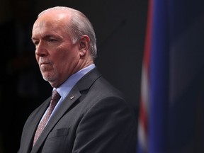 Premier John Horgan looks on during a press conference at Legislature in Victoria, B.C., on Monday, February 23, 2020.
