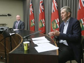 Manitoba Premier Brian Pallister and Dr. Brent Roussin, Manitoba chief public health officer, speak during the province's latest COVID-19 update at the Manitoba legislature in Winnipeg Monday, March 30, 2020.