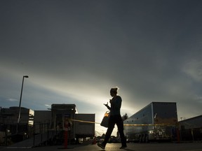 A health-care worker is silhouetted as she walks past the British Columbia mobile medical unit set up outside Abbotsford Regional Hospital in Abbotsford, B.C. Tuesday, April 14, 2020. The mobile medical unit was deployed to Abbotsford to assist with the COVID-19 outbreak that has occurred at the Mission Correctional Institution.