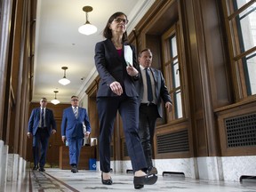 Quebec Health Minister Danielle McCann, Quebec Premier Francois Legault, right, and Horacio Arruda, Quebec director of National Public Health, centre, walk to a daily news conference conference on the COVID-19 pandemic, Wednesday, April 1, 2020 at the legislature in Quebec City.