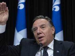 Quebec Premier Francois Legault responds to reporters during a news conference on the COVID-19 pandemic, Friday, April 10, 2020 at the legislature in Quebec City.