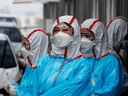 Medical staff in protective gear work at a 'drive-thru' testing center for the novel coronavirus disease of COVID-19 in Yeungnam University Medical Center in Daegu, South Korea.