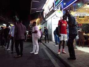 This file photo taken on March 2, 2018 shows people gathering on a street in the "Little Africa" district in Guangzhou, the capital of southern China's Guangdong province.