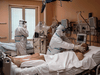 Doctors attend to patients in intensive care in the COVID-19 ward of the Maria Pia Hospital in Turin, Italy, on April 7, 2020.