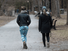 Two women ignore social distancing as they walk at Lafontaine park in Montreal on April 1, 2020.