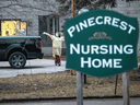 Workers wave at passing cars honking their horns in support for Pinecrest Nursing Home after several residents died and dozens of staff were sickened by COVID-19 in Bobcaygeon, Ontario, March 30, 2020.