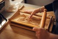 Ema Costantini uses a chitarra to cut strands of pasta