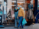 Pedestrians walk past open shops in Leipzig, eastern Germany, on Monday. Parts of Germany have started to relax lockdown measures introduced last month to slow the spread of the COVID-19, but big events are banned until Aug. 31.