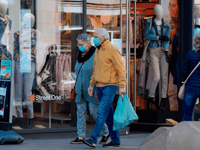 Pedestrians walk past open shops in Leipzig, eastern Germany, on Monday. Parts of Germany have started to relax lockdown measures introduced last month to slow the spread of the COVID-19, but big events are banned until Aug. 31.