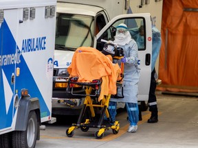 A paramedic transports a patient to Mount Sinai Hospital as the number of the coronavirus disease (COVID-19) cases continues to grow in Toronto, Ontario, Canada April 17, 2020.