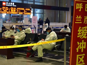 Police officers in protective suits are seen at an airport in Harbin, capital of Heilongjiang province bordering Russia, following the spread of the novel coronavirus disease (COVID-19) continues in the country, China April 11, 2020.