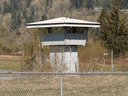 A guard tower at the Mission Institution correctional facility's medium security wing, where a prisoner who recently died from COVID-19 complications was held.