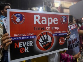 In this Dec.4, 2019 photo, demonstrators hold placards to protest against sexual assaults on women.