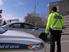 A Gatineau Police officer keeps a safe distance from a motorist on Portage Bridge while questioning him about where he is going, April 15, 2020.