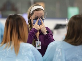 Medical staff participate in a training session as they prepare for the opening of the COVID-19 Assessment Centre at Brewer Park Arena in Ottawa, during a media tour on Friday, March 13, 2020. The federal government is looking to recruit volunteers with medical experience as backup in the fight against COVID-19.