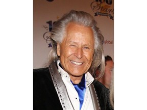 Peter Nygard arrives at the 24th Night of 100 Stars Oscars Viewing Gala at The Beverly Hills Hotel in Beverly Hills, Calif., on March 2, 2014. Dozens more women, including Canadians, have added their names to a class action lawsuit alleging rape and sexual assault by fashion mogul Nygard.