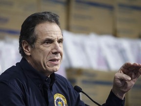 IN this March 24, 2020 file photo, New York Gov. Andrew Cuomo speaks during a news conference in New York. Cuomo is pushing back against what he calls "political pressure" on the United States to restart its paralyzed economy.