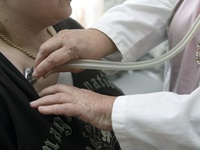 A doctor examines a patient with a stethoscope in her doctor's office in Stuttgart, Germany, Monday, April 28, 2008.