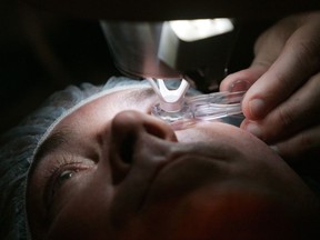 In this Nov. 1, 2005 file photo, a doctor prepares a patient for eye surgery in Chicago. Doctors say they're becoming increasingly concerned about how they're going to handle the swelling backlog of elective surgeries once the immediate COVID-19 threat has ebbed.THE CANADIAN PRESS/AP/Charles Rex Arbogast