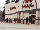 People social distance as they stand in line to get in a grocery store in Fort Qu'Appelle, Saskatchewan on April 17, 2020.