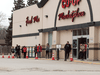People social distance as they stand in line to get in a grocery store in Fort Qu’Appelle, Saskatchewan on April 17, 2020.