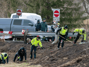 RCMP investigators search for evidence at the location where Const. Heidi Stevenson was killed during a mass shooting along the highway in Shubenacadie, N.S., on April 23, 2020.