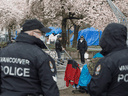 Vancouver Police officers patrol at Oppenheimer Park in Vancouver's downtown eastside, March 26, 2020.