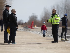 City officials look for Torontonians not abiding by new social-distancing directives at Woodbine Beach, on Saturday April 11, 2020.