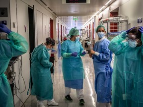 Nurses dress themselves in personal protective equipment (PPE) on a ward for covid-19 positive patients at the Sant Pau hospital in Barcelona, Spain, on Thursday, April 2, 2020. Spain reported the lowest number of new coronavirus cases in more than two weeks, a sign that Europe’s biggest outbreak is slowing.