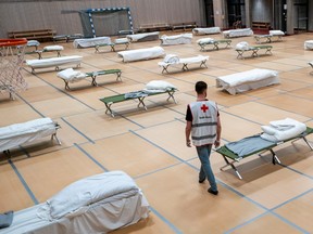 Beds for the homeless are arranged to provide required distance to reduce the risk of coronavirus infection (COVID-19) in the gym of Uranienborg School in Oslo, Norway March 25, 2020.