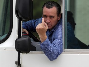 Pastor Tony Spell talks to the media as he drives a bus of congregants from Life Tabernacle Church after Easter church services on April 12, 2020 in Central, Louisiana. Pastor Spell has been holding in-person services despite Louisiana Gov. John Bel Edwards' ban on gatherings of 50 or more people.