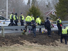 RCMP investigators search for evidence at the location where Const. Heidi Stevenson was killed along the highway in Shubenacadie, N.S. on Thursday, April 23, 2020. Police say the man who went on a murderous rampage through five Nova Scotia communities was likely using unlicensed firearms, and investigators are trying find out how he obtained illegal weapons.