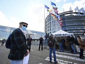 A man wearing a protective facemask queues at a COVID-19 testing centre at the European Parliament on May 12, 2020, in Strasbourg, eastern France.