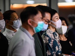 Tanya Chan (centre right) of the Civic Party and other pro-democracy lawmakers gather  for a press conference in Hong Kong late on May 21, 2020. China's parliament said on May 21 it will discuss a proposal for a national security law in Hong Kong at its annual session, in a move likely to stoke unrest in the financial hub.