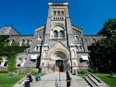 People pass University College at the University of Toronto, in 2011.