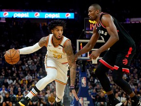 Mar 5, 2020; San Francisco, California, USA; Golden State Warriors forward Marquese Chriss (32) drives the ball around Toronto Raptors center Serge Ibaka (9) during the fourth quarter at Chase Center.