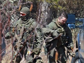 Royal Canadian Mounted Police (RCMP) members pack up after the search for Gabriel Wortman in Great Village, Nova Scotia, Canada April 19, 2020.