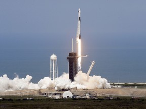 A SpaceX Falcon 9, with NASA astronauts Doug Hurley and Bob Behnken in the Dragon crew capsule, lifts off from Pad 39-A at the Kennedy Space Center in Cape Canaveral, Fla., Saturday, May 30, 2020.