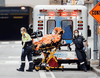 Paramedics take a patient into St. Michael’s Hospital in Toronto on March 31.